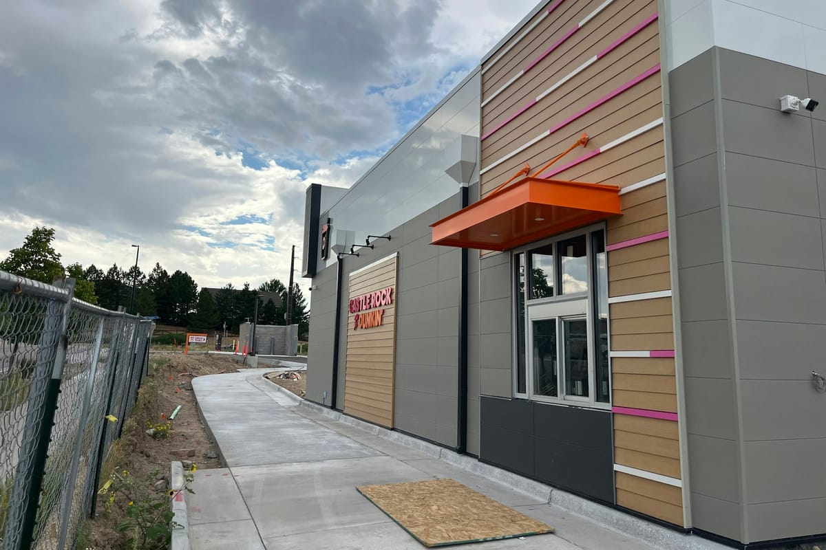 The Castle Rock ♥ Dunkin' sign beside the drive-thru window before opening