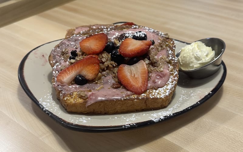 Egg Harbor Cafe's berry-topped French toast, photographed at the Highlands Ranch location — a second Colorado spot is coming to Belleview Station in Denver