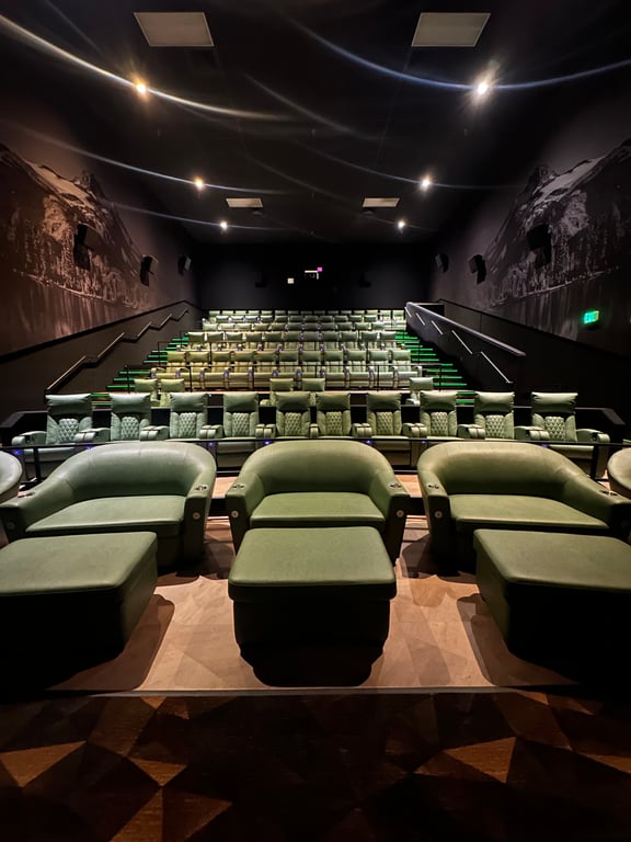 An Emagine Parker auditorium with a Colorado mountain landscape mural running across the ceiling above the recliner rows.