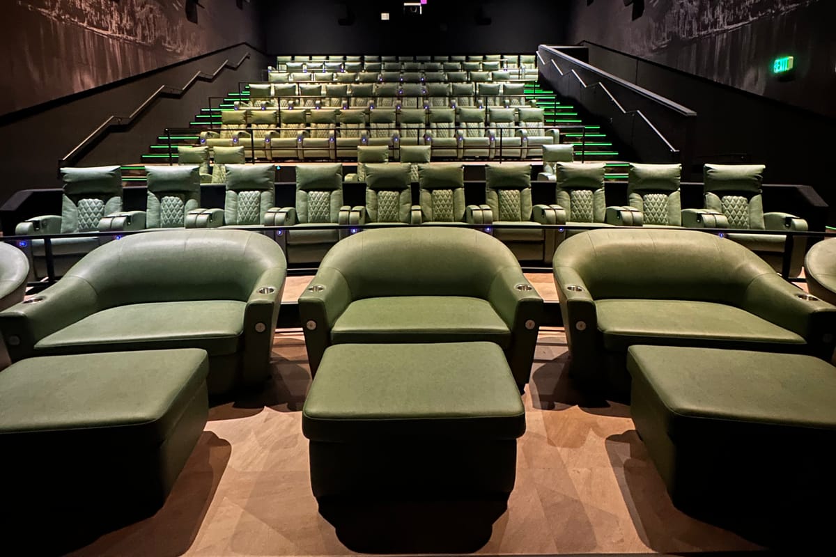 An Emagine Parker auditorium with a Colorado mountain landscape mural running across the ceiling above the recliner rows.