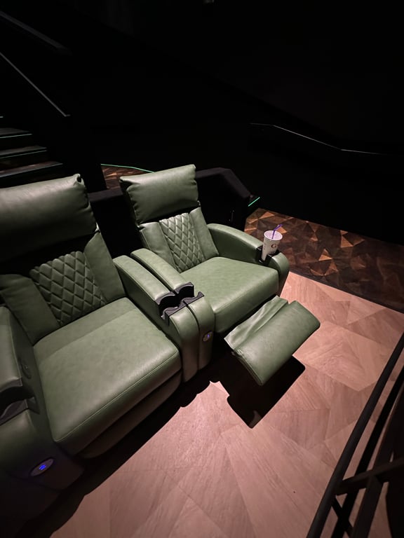 Heated recliners in a row at Emagine Parker, with quilted leather and warm wood-paneled walls.