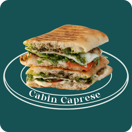 Cabin Caprese panini at Griddled Castle Rock — mozzarella, Roma tomatoes, arugula, pesto, balsamic glaze