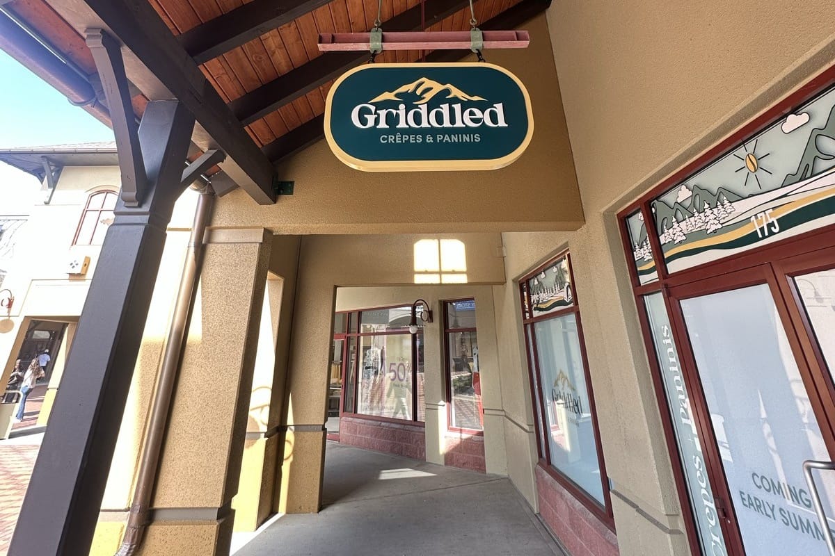 The hanging Griddled Crêpes & Paninis sign under the timber walkway at the Outlets at Castle Rock