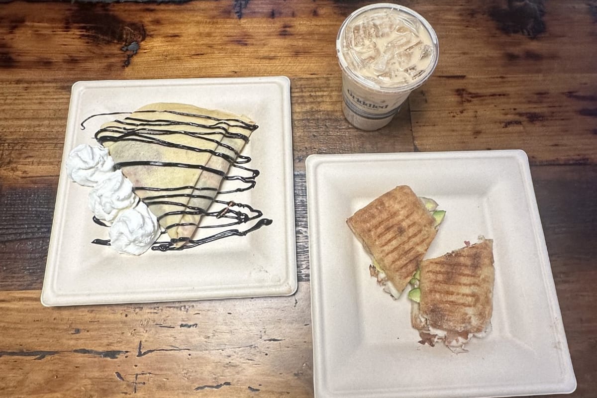 A drizzled crepe plus a pressed panini and an iced latte at Griddled