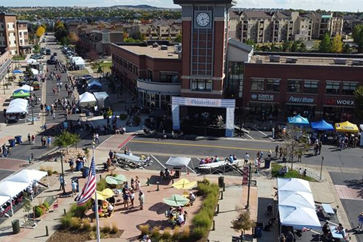 Highlands Ranch Town Center from above during Oktoberfest, with the clock tower, the stage and vendor tents along Dorchester Street