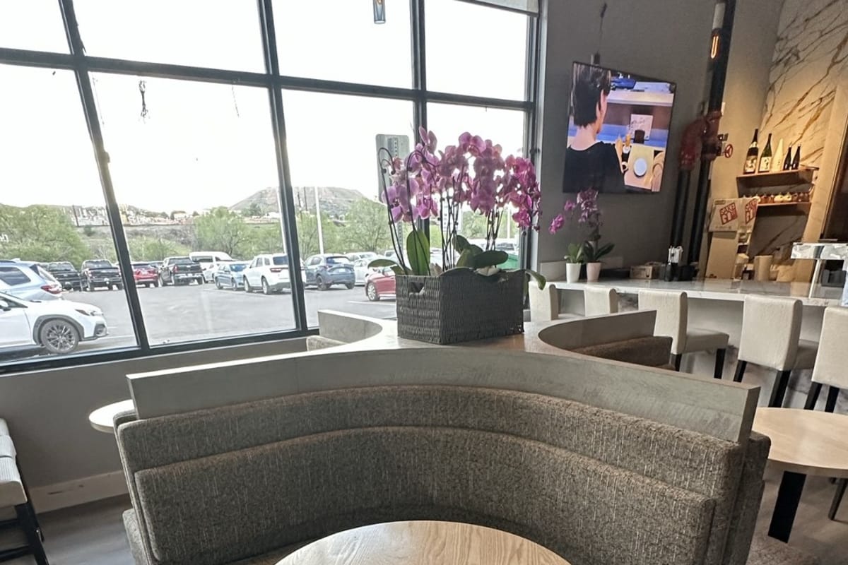 Izumi Sushi entry 2-top with curved booth and window view to Third Street