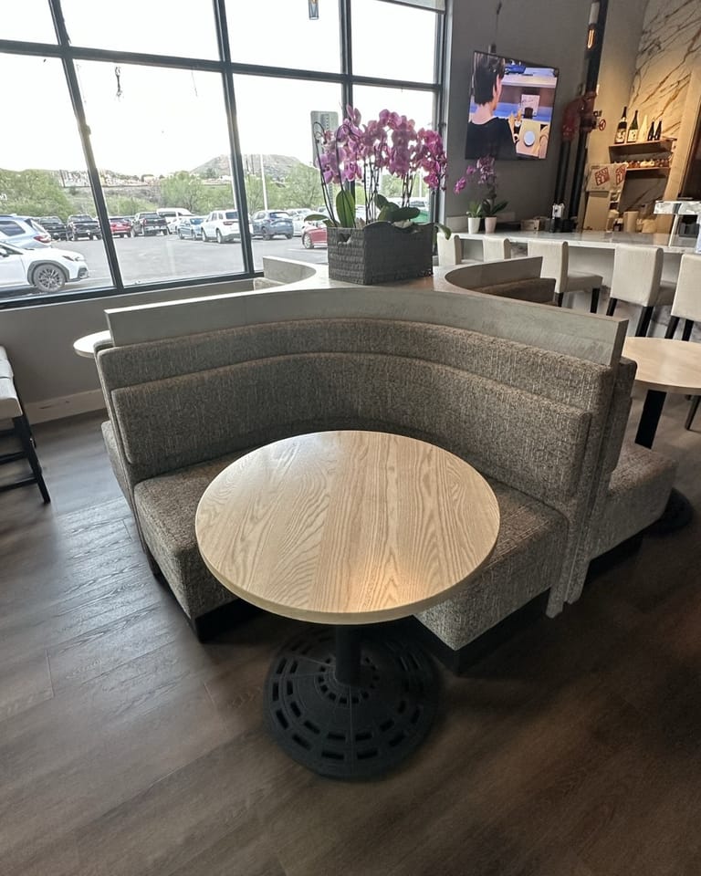 Izumi Sushi entry 2-top with curved booth and window view to Third Street