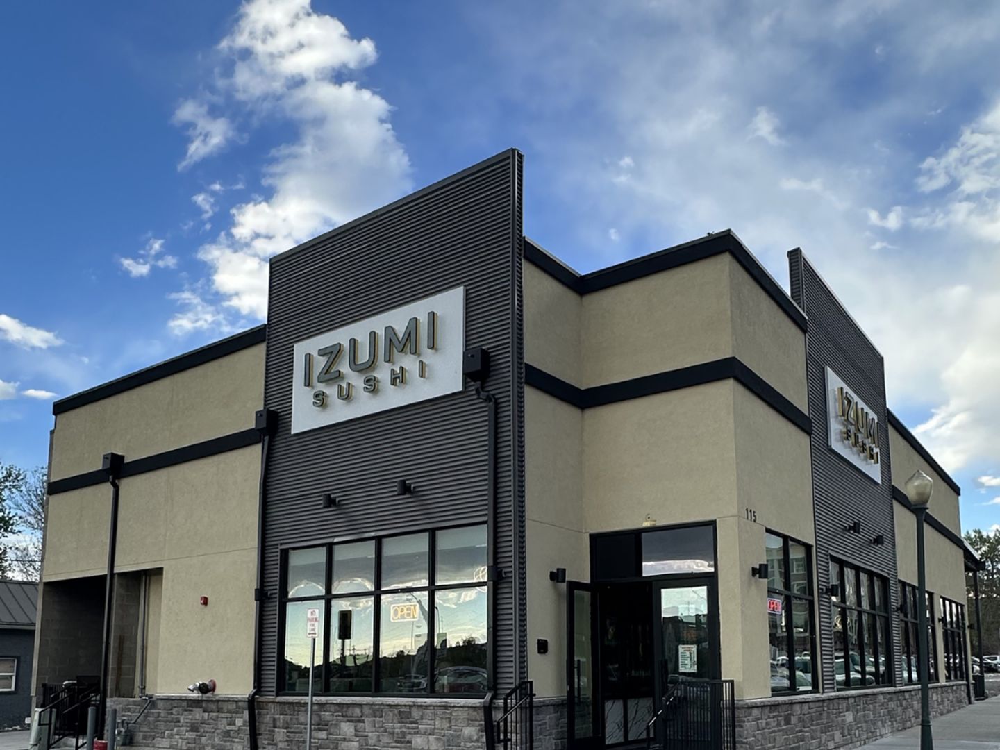 Izumi Sushi storefront with prominent signage on Third Street in downtown Castle Rock, Colorado.