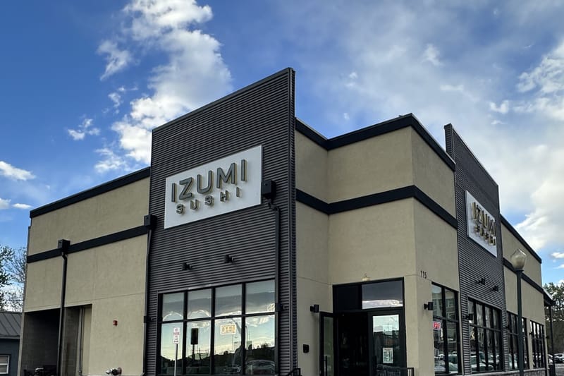 Izumi Sushi storefront with prominent signage on Third Street in downtown Castle Rock, Colorado.