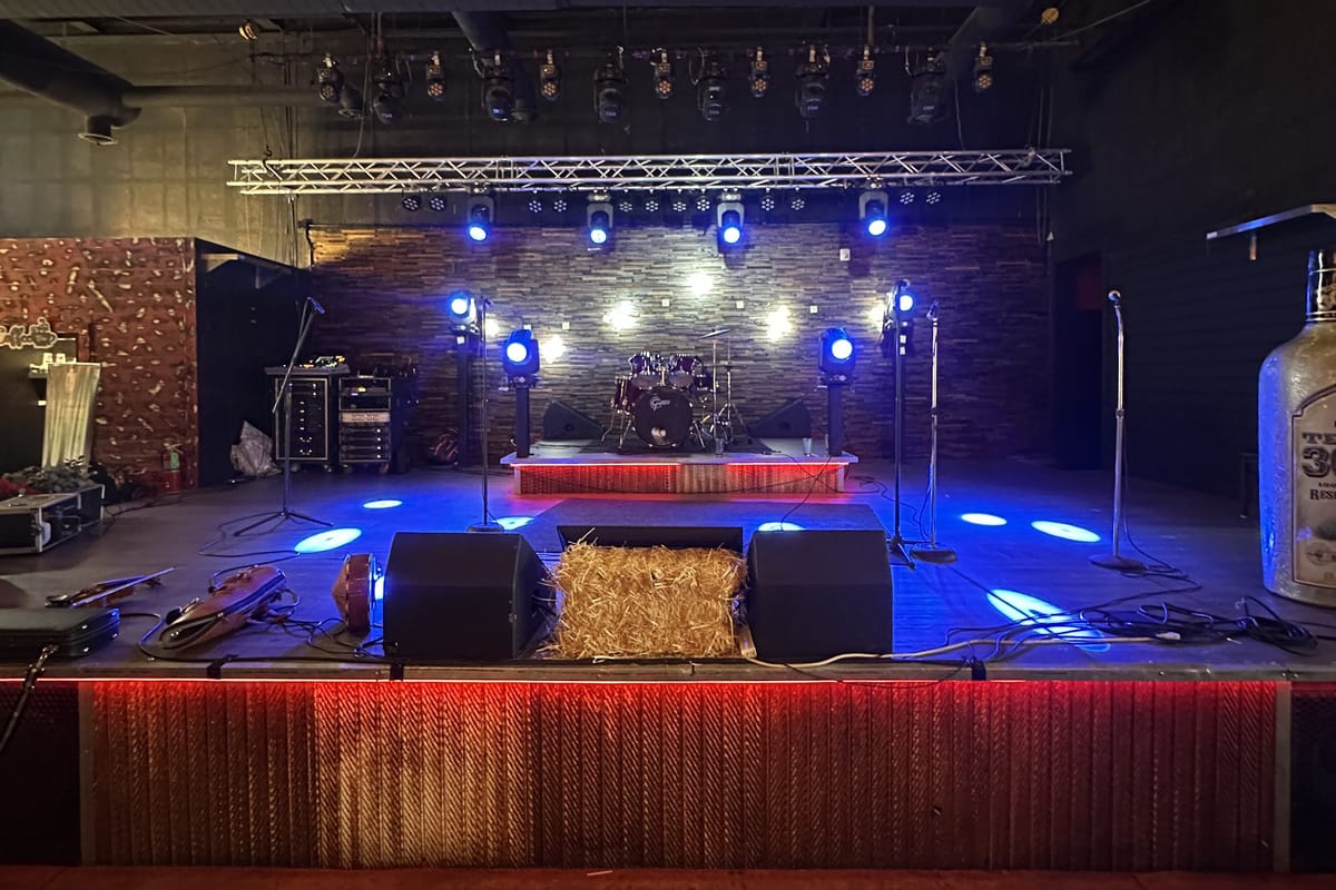 The indoor stage at JP Cocina & Cantina, with drum kit and lighting rig