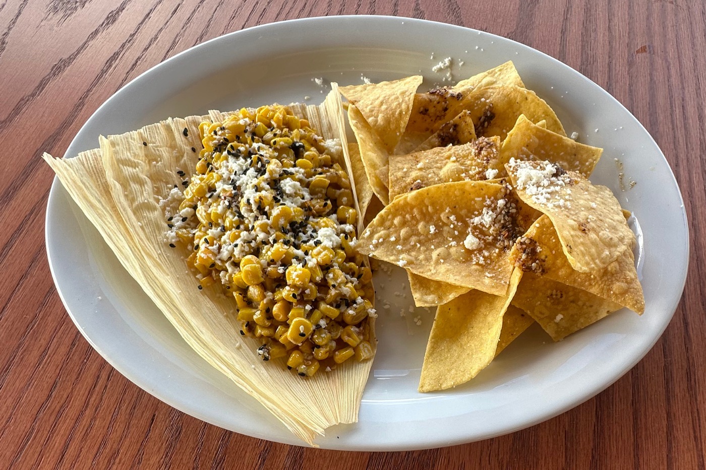 Street Corn, $7, off the cob in a husk under cotija and salsa macha