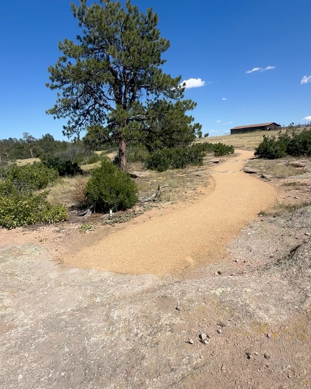 Pronghorn Path at Lost Canyon Ranch Open Space, a flat crusher-fines trail through open grassland with an old ranch shed, Castle Rock