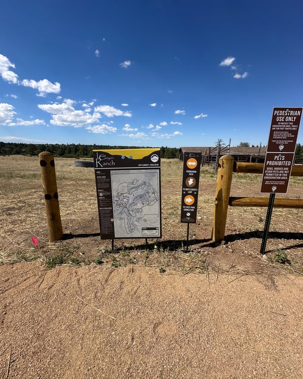 The Cattleman's Trailhead map board and rule signs at Lost Canyon Ranch Open Space, Castle Rock, showing the trail map and the Pedestrian Use Only and Pets Prohibited signs