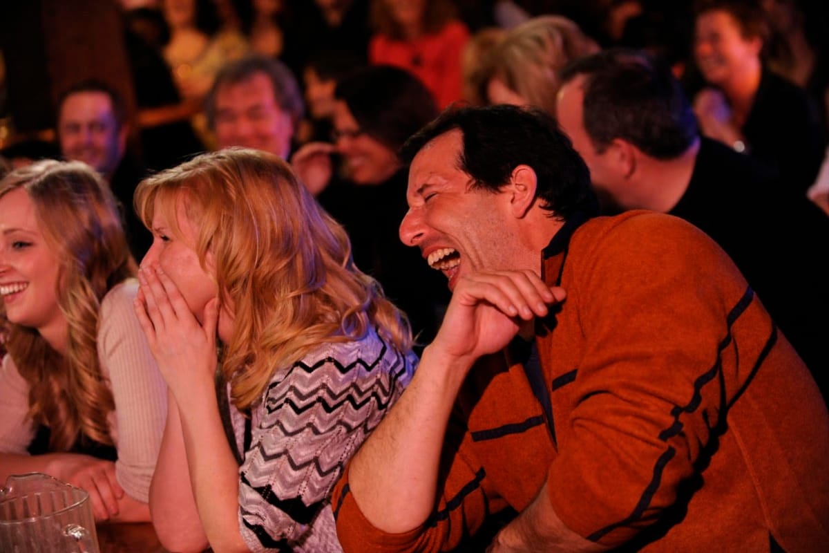 Guests laughing in the front row during a Magic Manor show