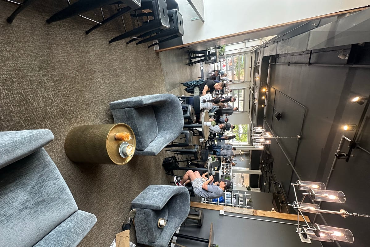 Lounge seating with brass side tables inside Monk & Mongoose's RidgeGate coffee shop in Lone Tree