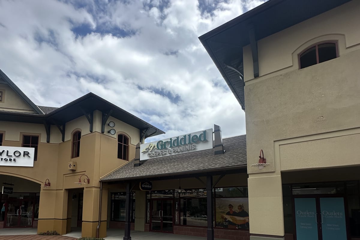 Griddled Crepes and Paninis storefront with Outlets Customer Service door at Outlets at Castle Rock