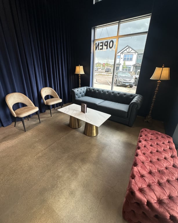 Front lounge at Champagne Velvet Proper Kitchen & Bar — chesterfield sofa, marble coffee table on gold pedestals