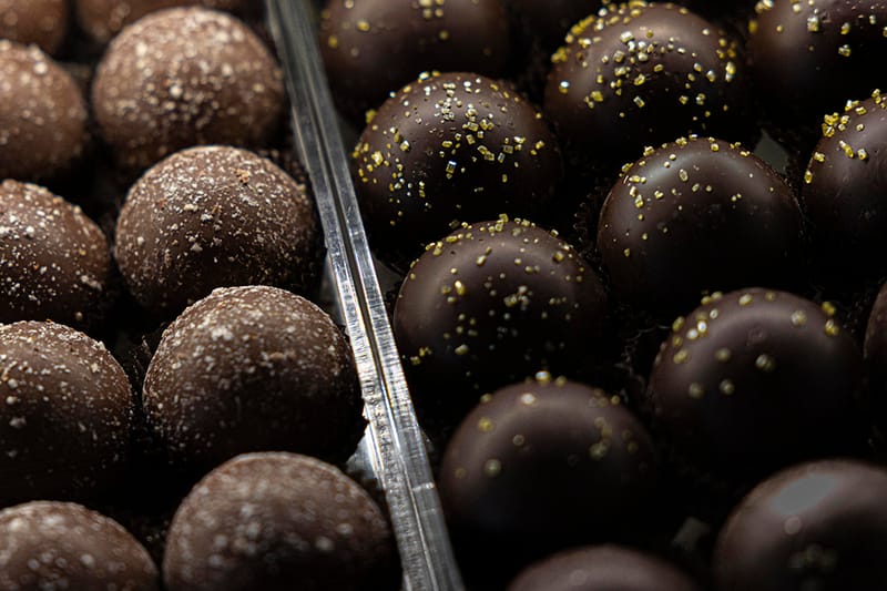 Rocky Mountain Chocolate Factory Café candy case at Outlets at Castle Rock — handcrafted truffles, caramel apples, and chocolate displays