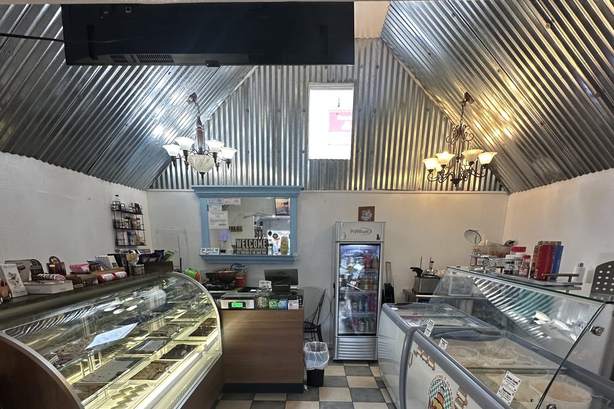The Magill's ice cream freezer now sits opposite the chocolate case, under a corrugated metal ceiling and chandeliers