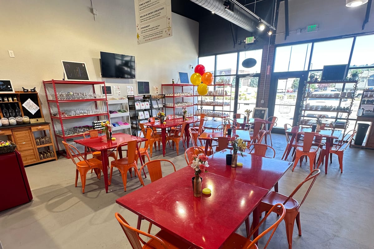 Colorful interior seating with red tables and orange chairs at The Hot Spot Studios in Castle Rock