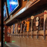 Whiskey bottles and beer taps behind the bar at The Whiskey Lodge in Castle Rock