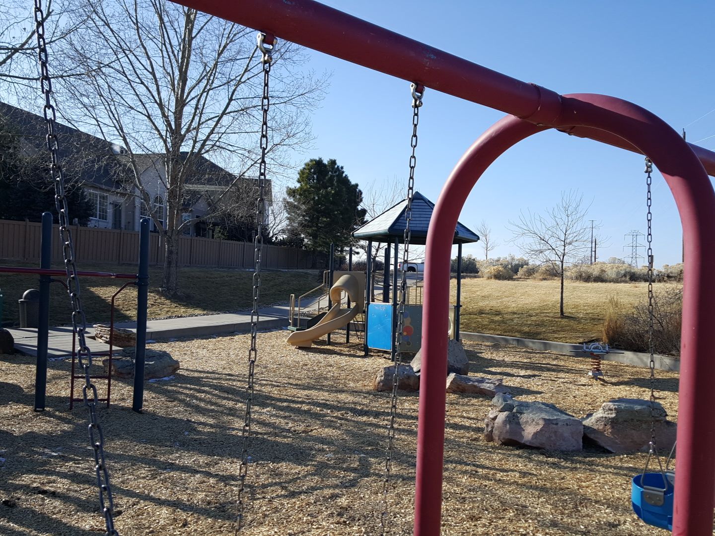 Swings and the playground at Daniels Gate Park in Castle Pines