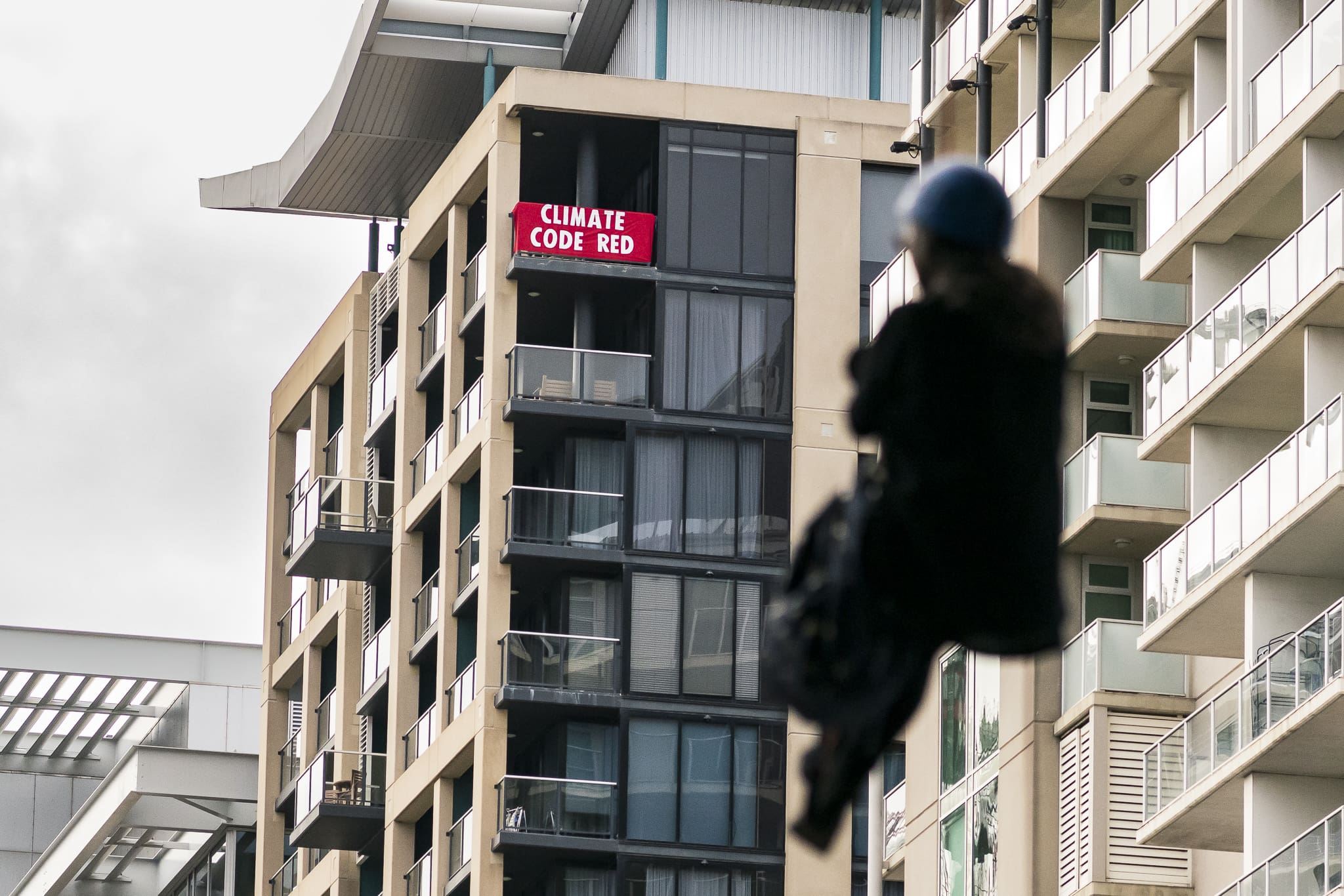 A keen supporter unfurls a banner off their balcony reading 