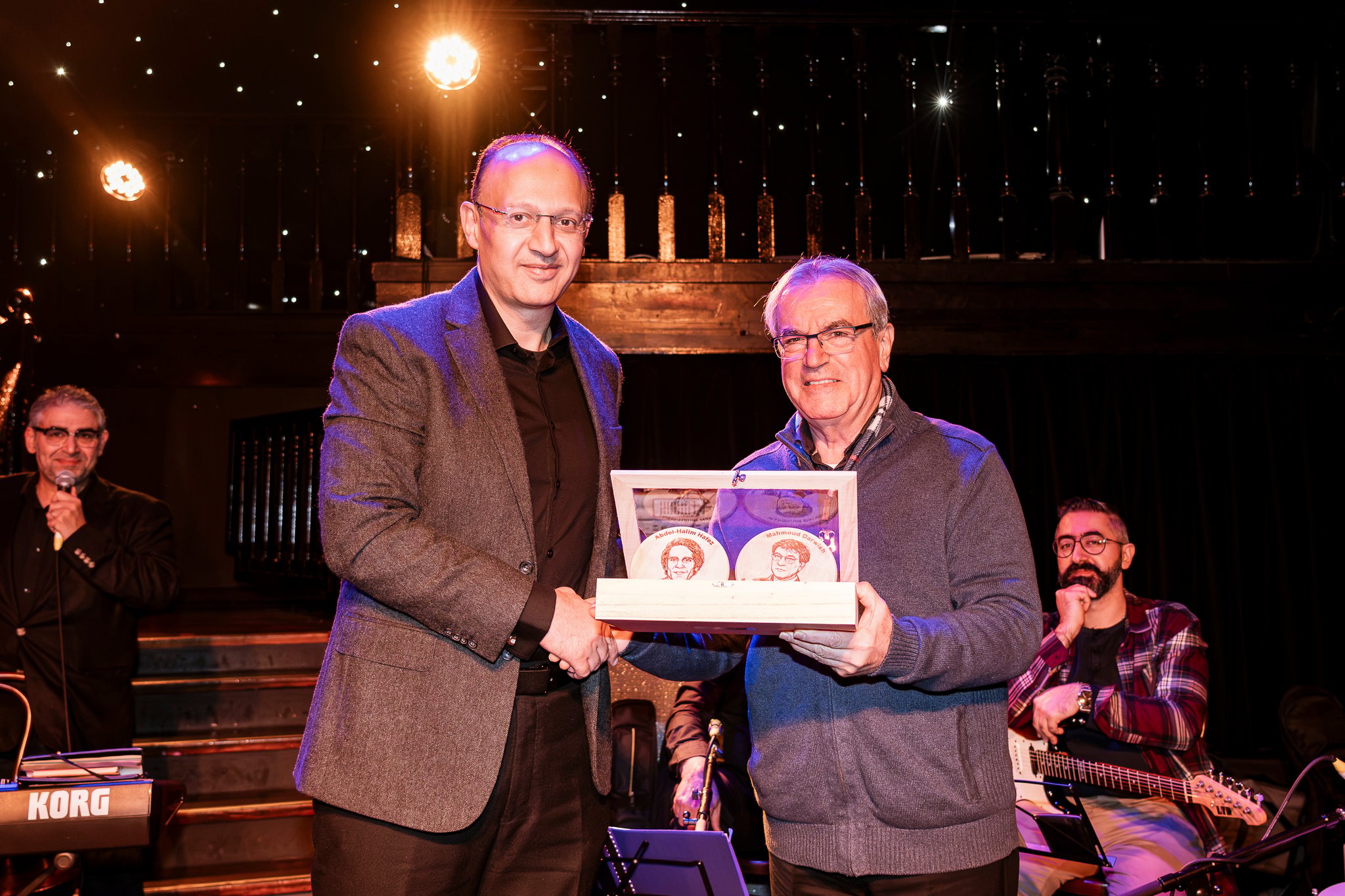 Mr Haitham Mokhtar Abdelraouf Ibrahim, Consul-General of Egypt in Melbourne, accepting a gift of wooden artwork of of Mahmoud Darwish and Halim; presented by Krikor Khaderian on behalf of Tarab Ensemble.