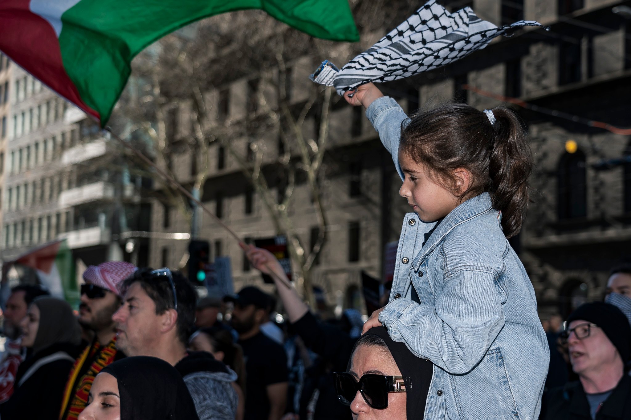 The march continues west down Bourke St.