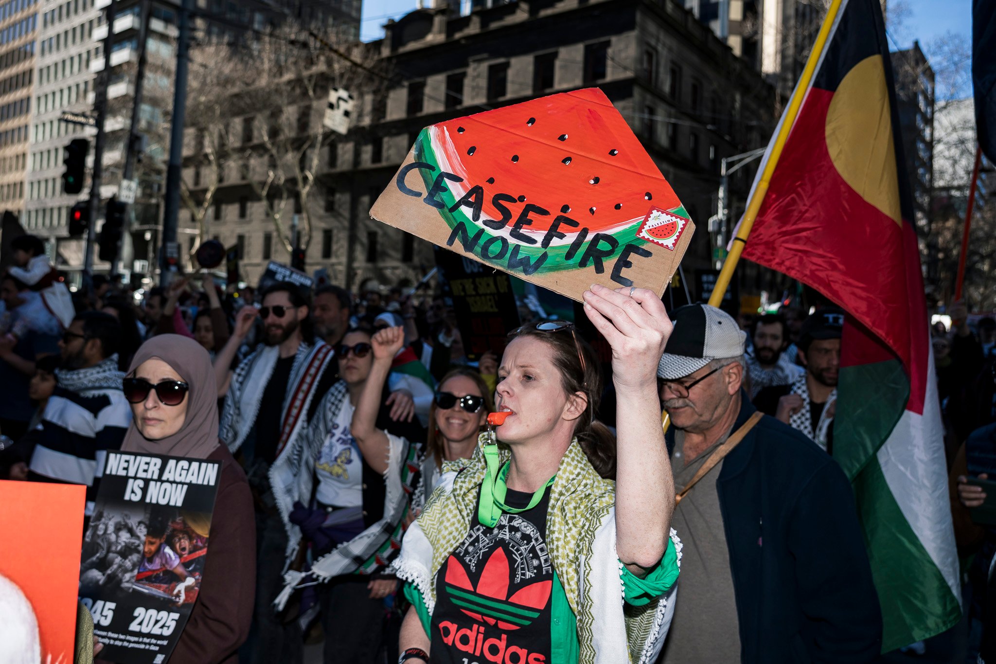 The march continues west down Bourke St.