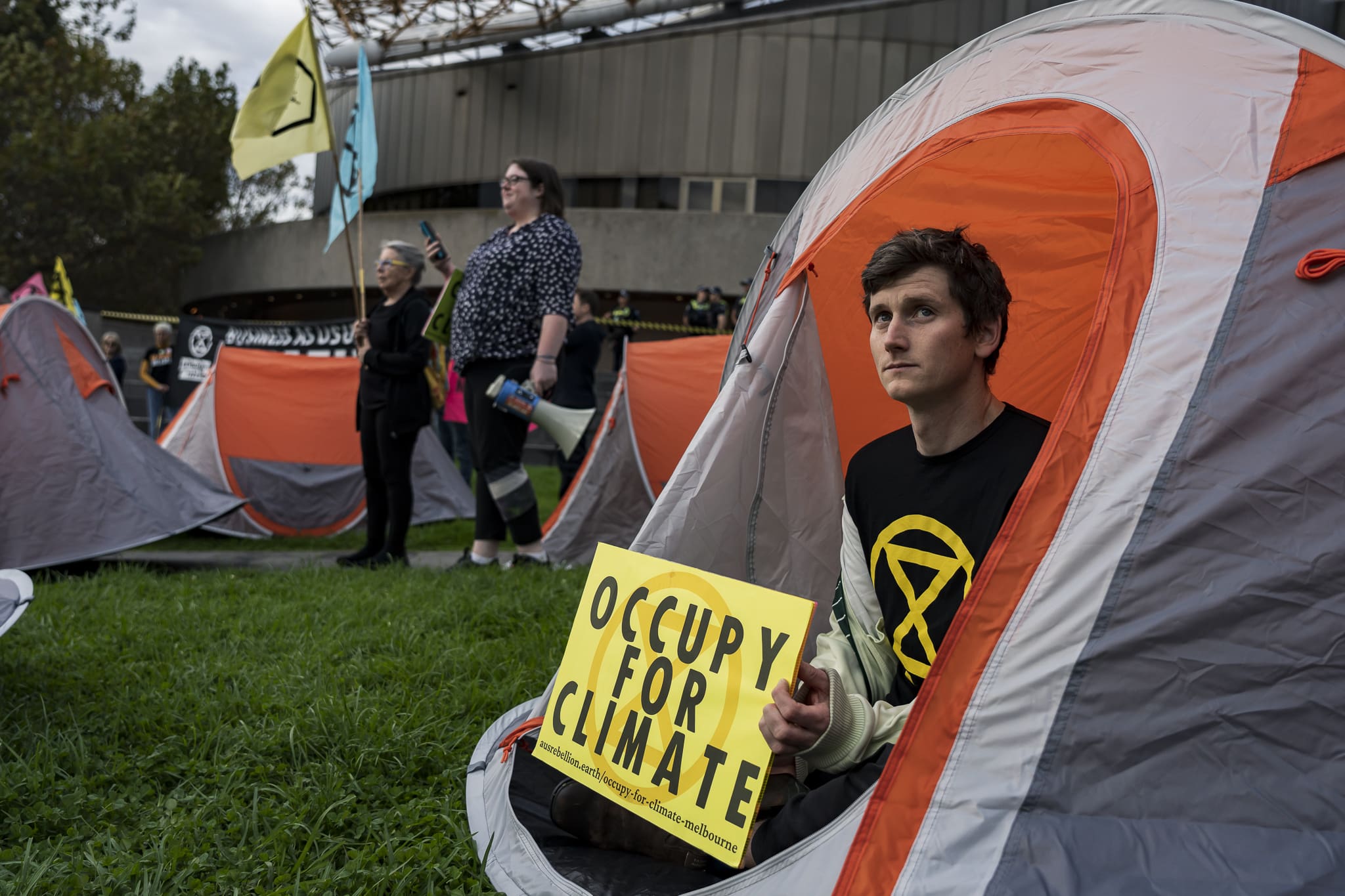Protesters sat in tents on the lawn adjacent to the Melbourne Arts Centre spire. Photo: Matt Hrkac