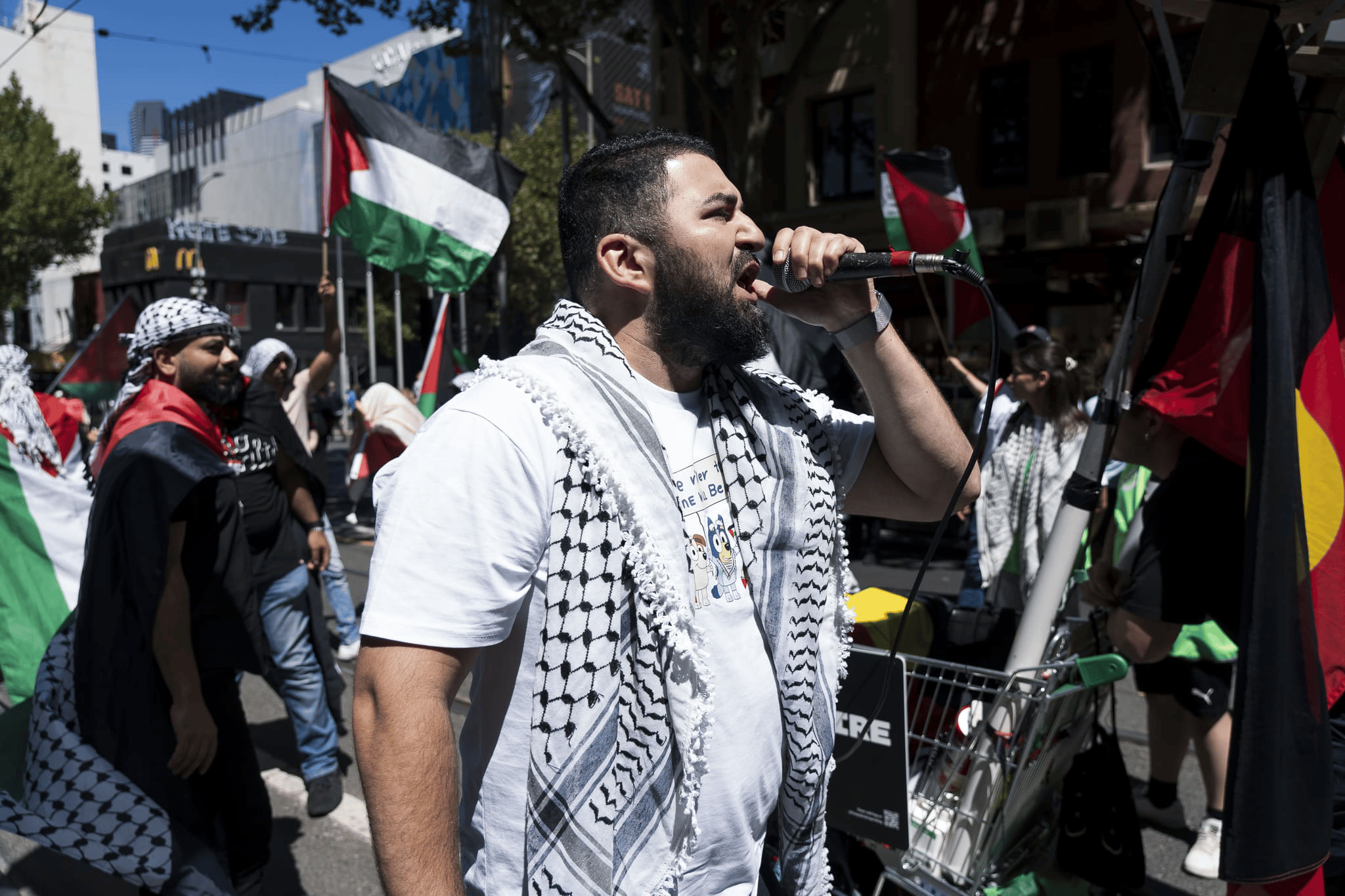 Hash Tayeh, Burgertory CEO, leading chants at the Palestine rally in Melbourne. Photo: Matt Hrkac