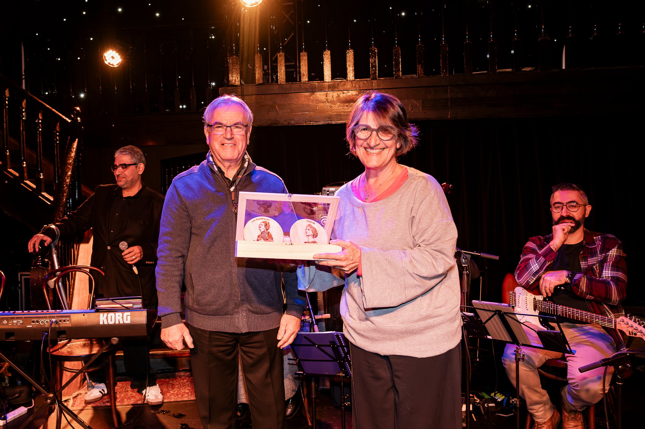 Former Federal Member of Parliament, Maria Vamvakinou, accepting agift of wooden artwork of Um Kulthoum and Fairuz - presented to her by Krikor Khaderian on behalf of Tarab Ensemble.