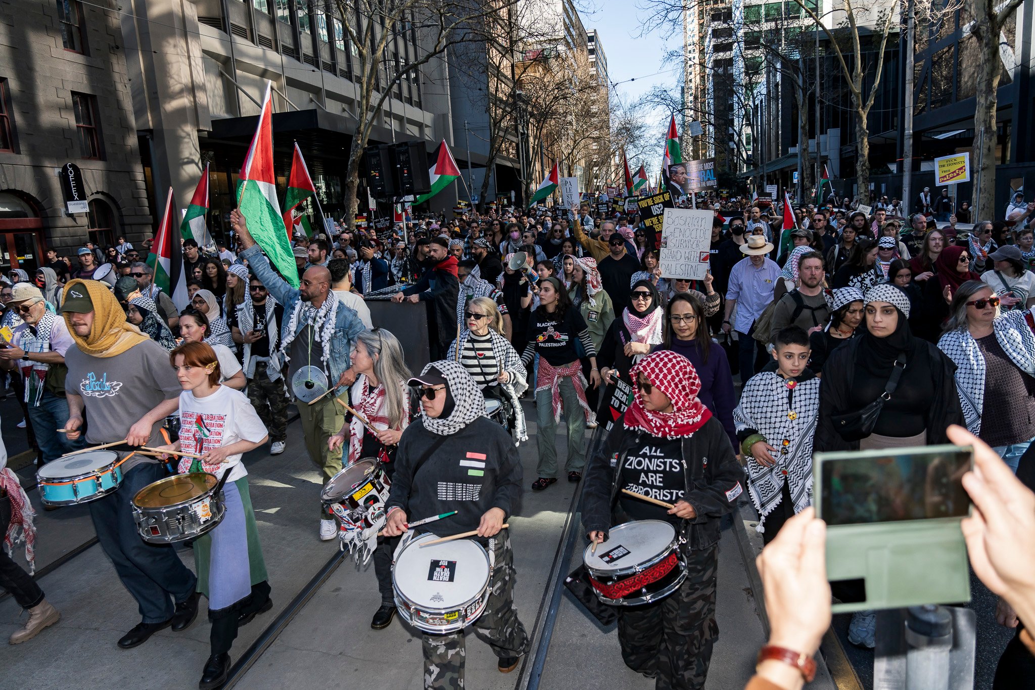 The march continues west down Bourke St.