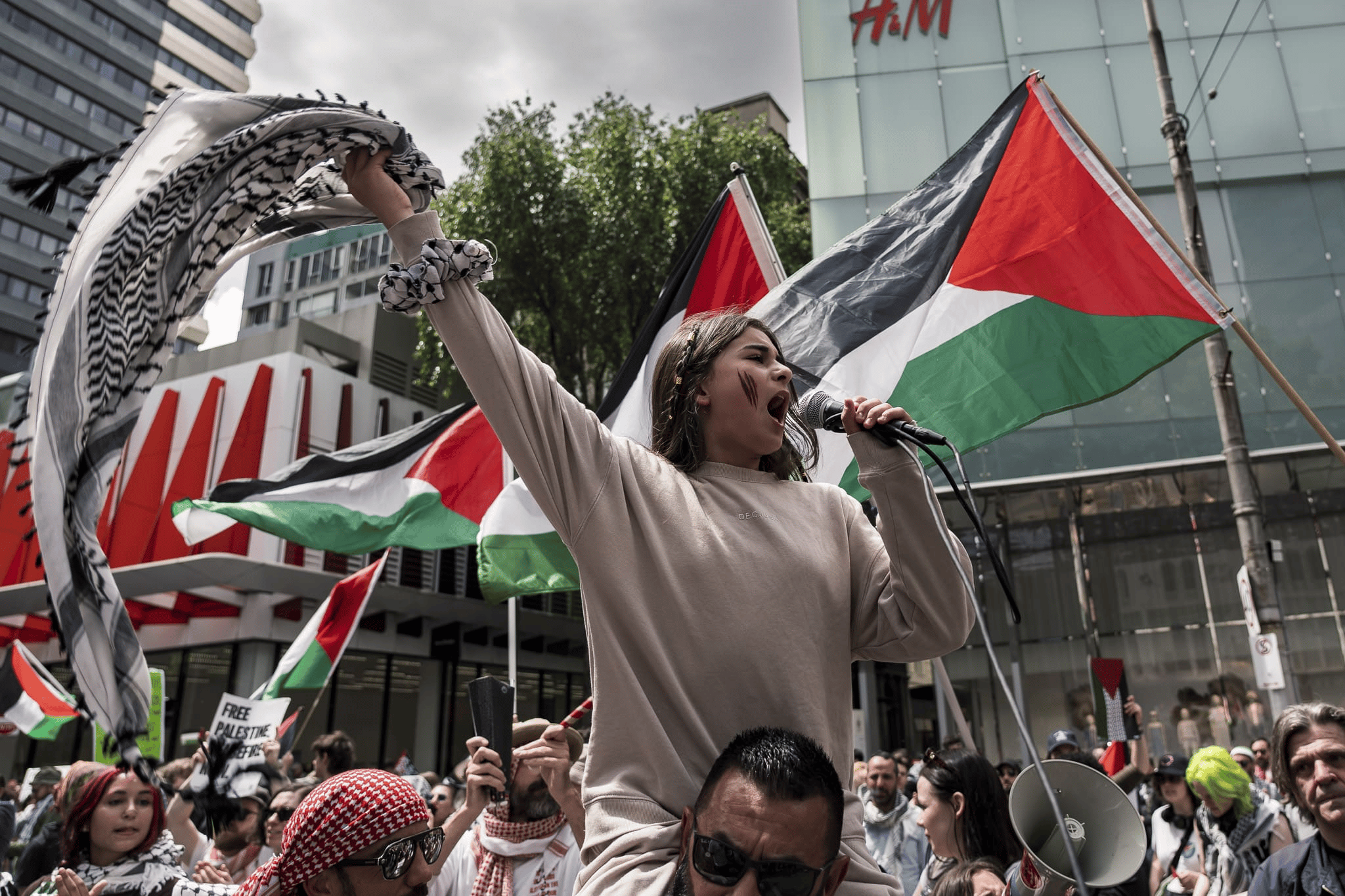 A young girl leads chants at a pro Palestine rally in Melbourne. Photo: Matt Hrkac