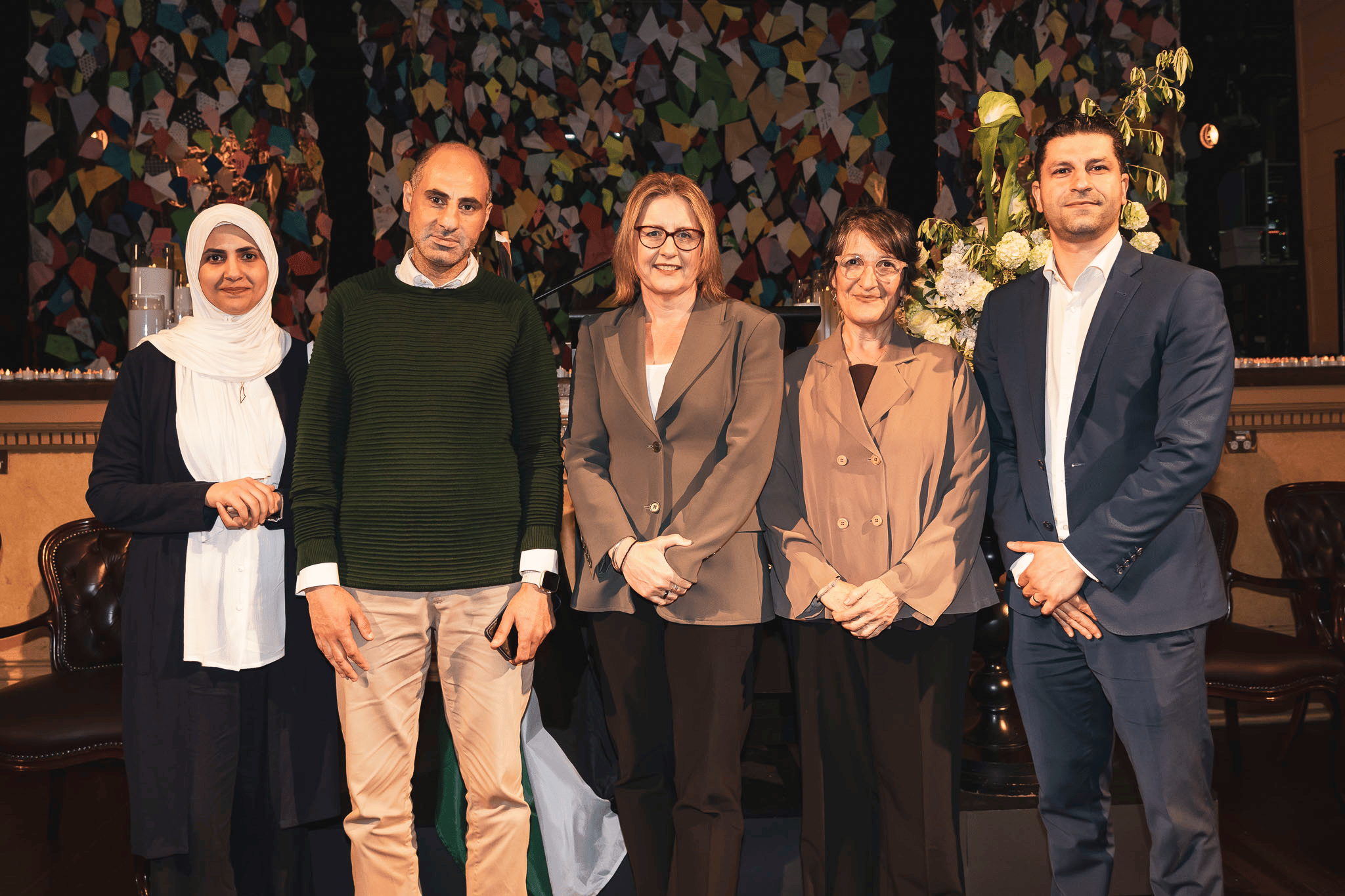 Victorian Premier Jacinta Allan stands in a group photo with Basim Abdo and Maria Vamvakinou, plus Palestinian refugees.