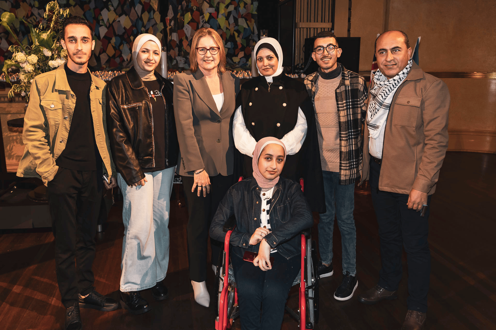 Victorian Premier Jacinta Allan stands in a group photo with Palestinian refugees.