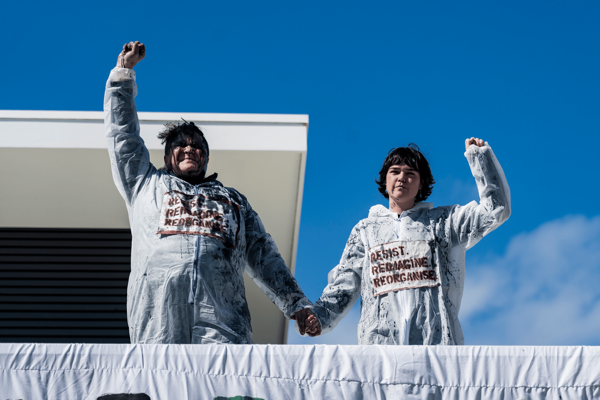 Protesters occupy the rooftop of the home of Viva Energy CEO Scott Wyatt