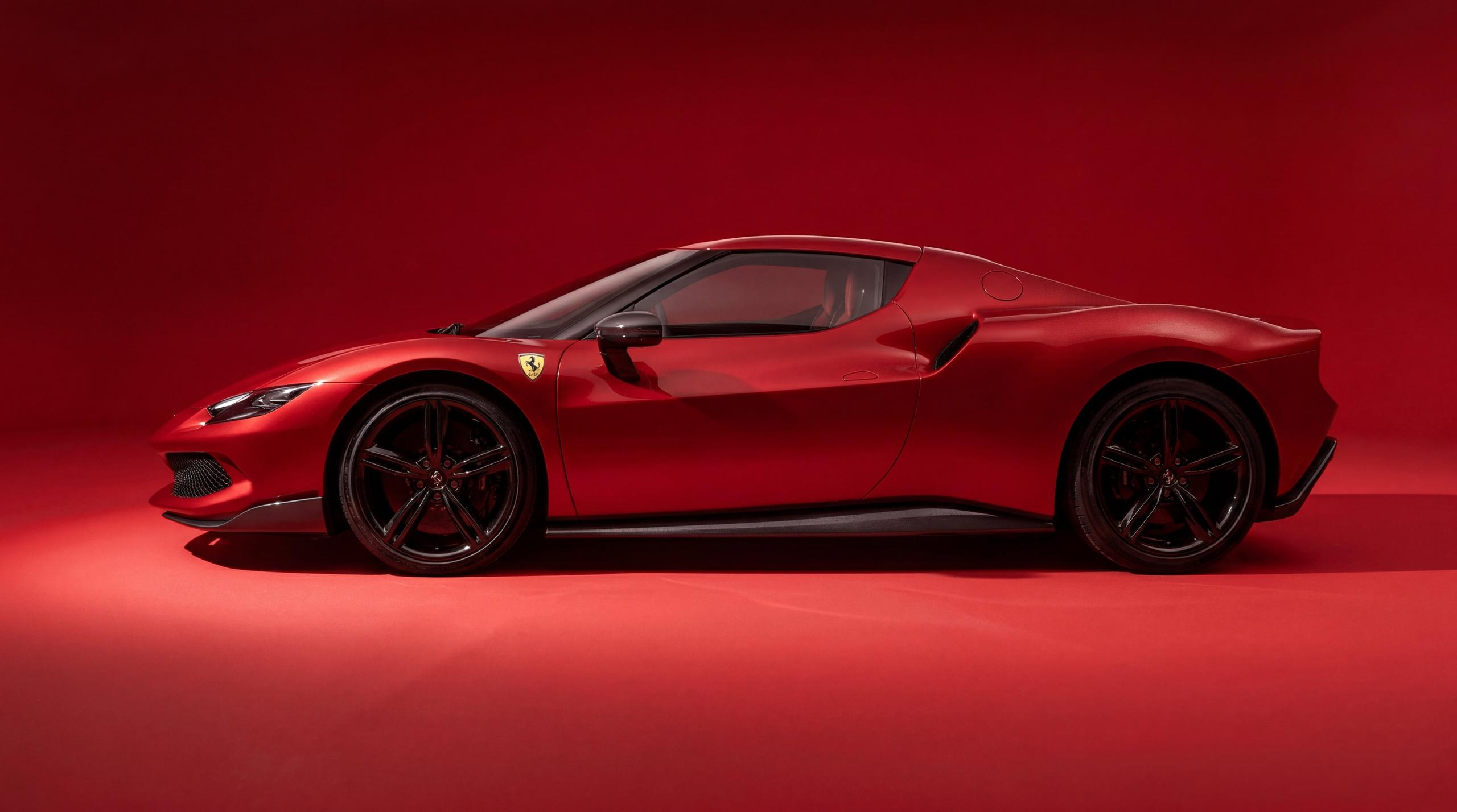 Red sports car in profile against a matching red studio backdrop