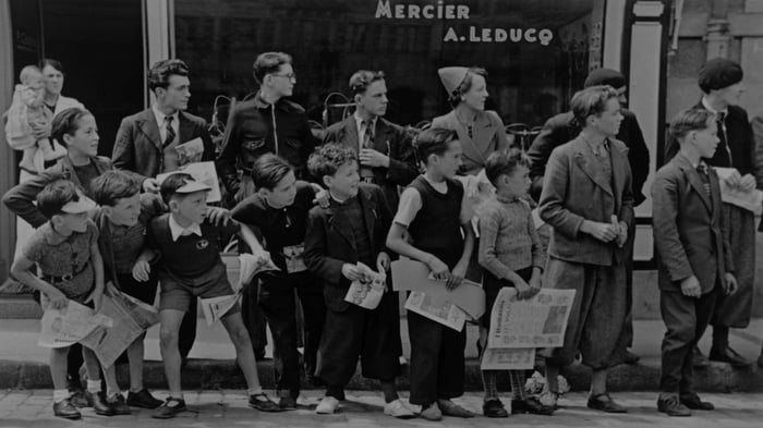 A crowd watching the Tour de France bicycle race in Pleyben, Brittany, France in july 1939