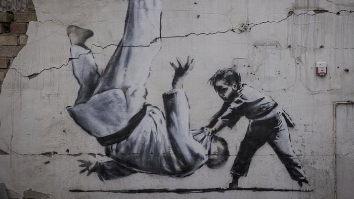 Child throwing a man on the floor in judo clothing, Borodyanka