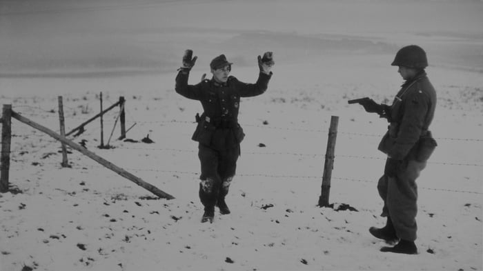 A US soldier with a German prisoner of war during the Battle of the Bulge