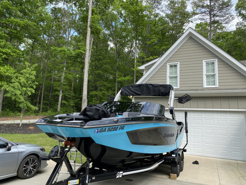 Blue Mastercraft boat on a trailer ready for summer