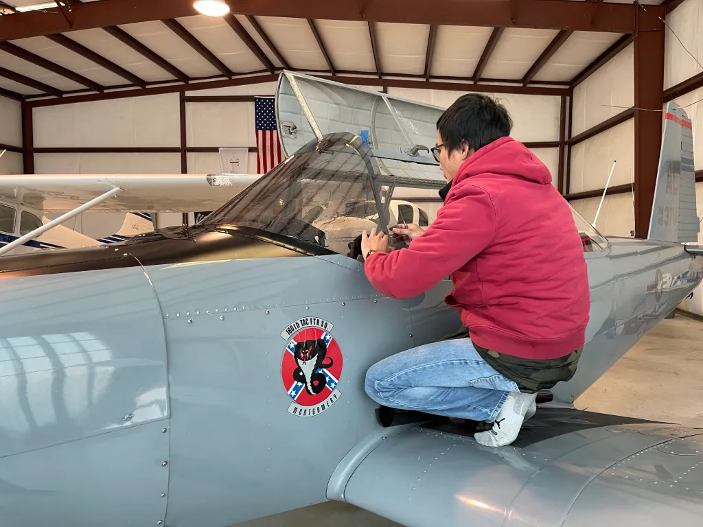 Professional tinting work on an airplane in a hangar
