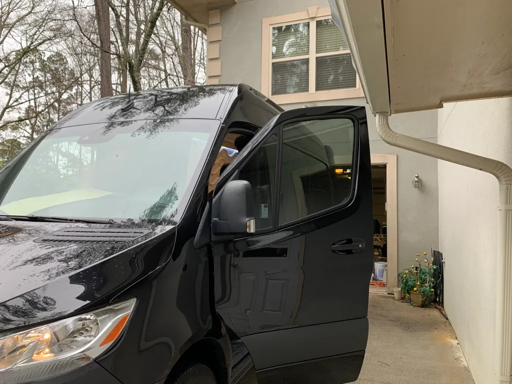 Mobile tinting service for a black commercial van