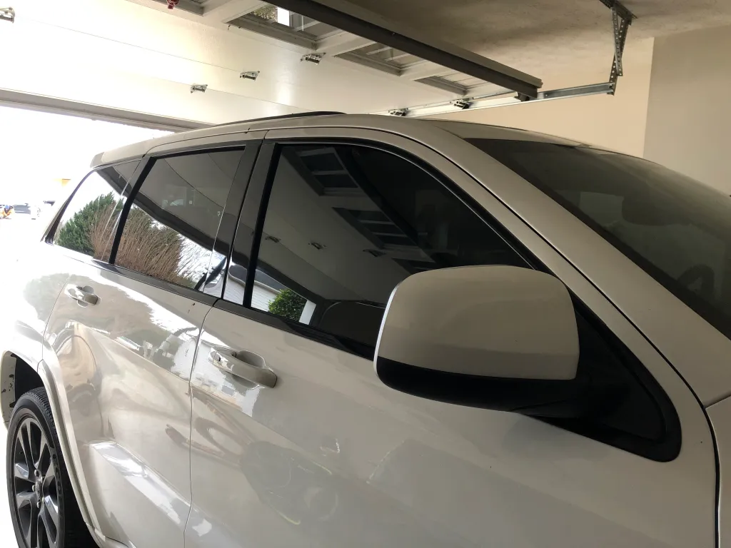White SUV with ceramic window film installed in residential garage
