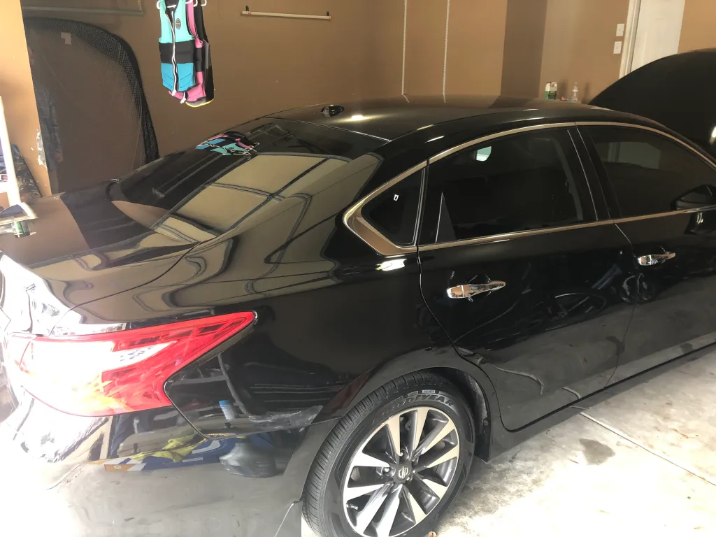 Luxury sedan ceramic window tint installation in garage - Marietta