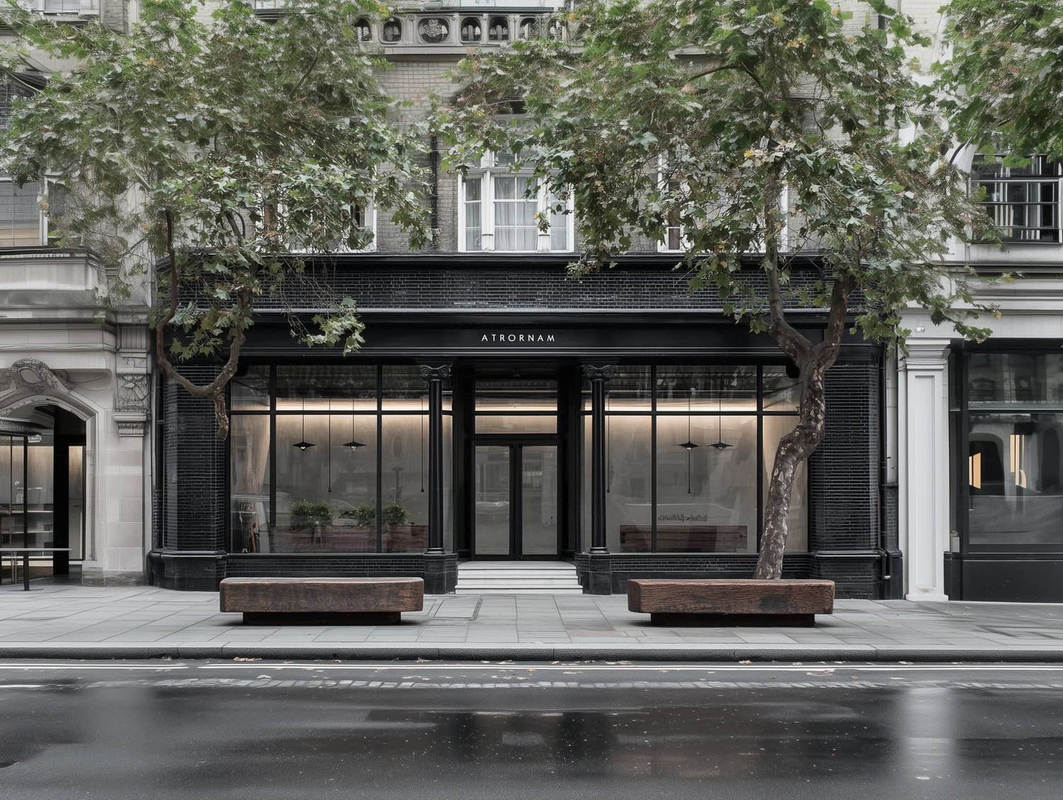 Sleek black storefront with large glass windows, street trees, and two wooden benches.