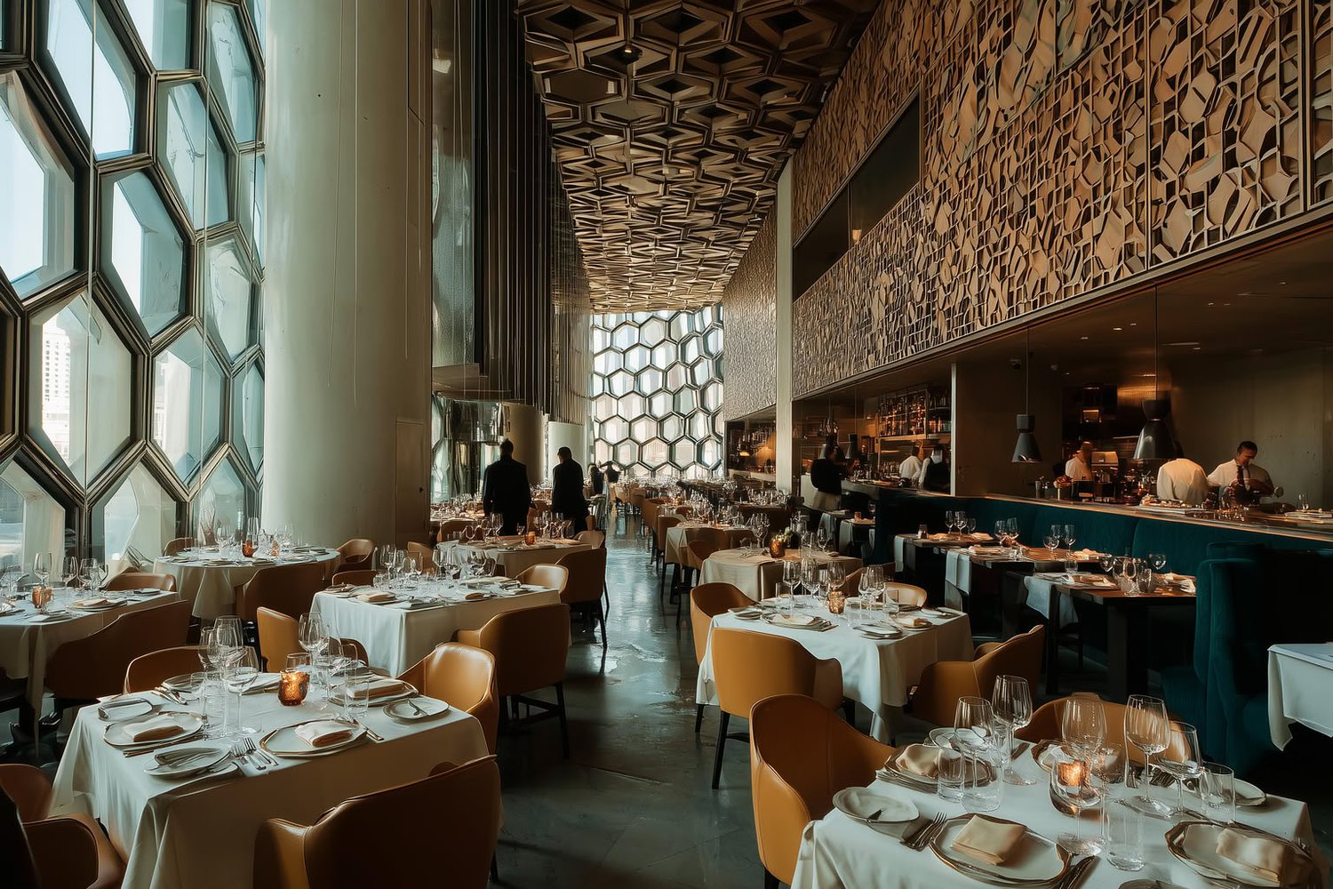 Modern restaurant with hexagonal windows, patterned ceiling, elegant tables, and warm lighting.