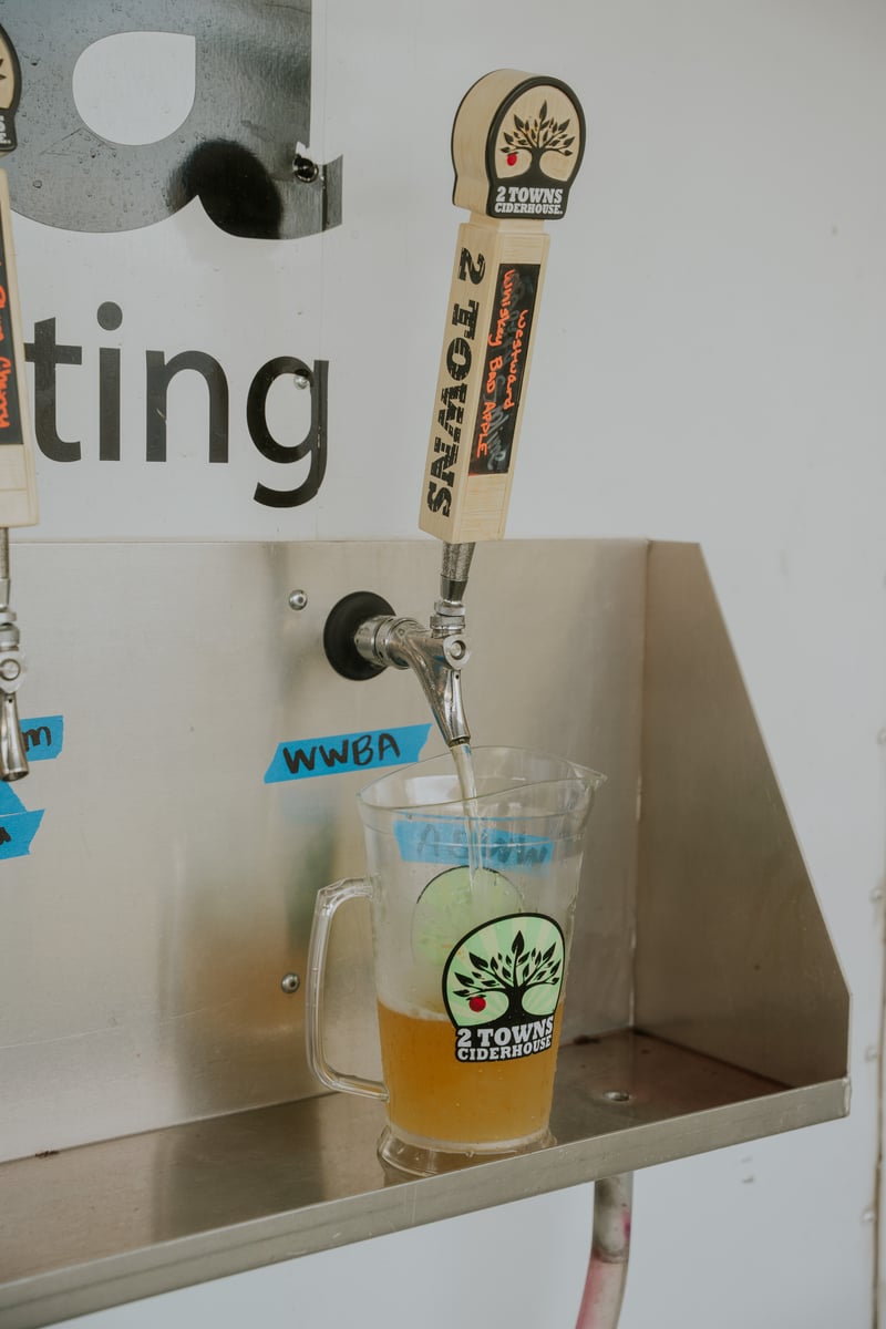 A cider being poured at the 2 Towns Ciderhouse Harvest Party 2025.